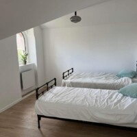 Light, spacious bedroom with twin beds, storage