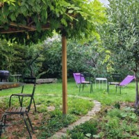 The Secret Garden - walled garden with wooden pergola and garden furniture