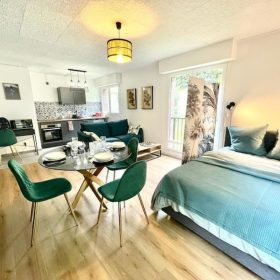 Open plan living dining and kitchen area with space for bed at Residence du Chateau